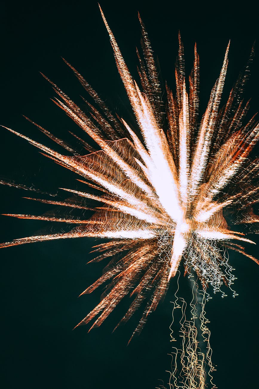 glowing bright fireworks in dark sky
