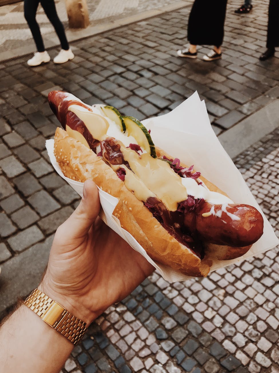 person holding hotdog sandwich