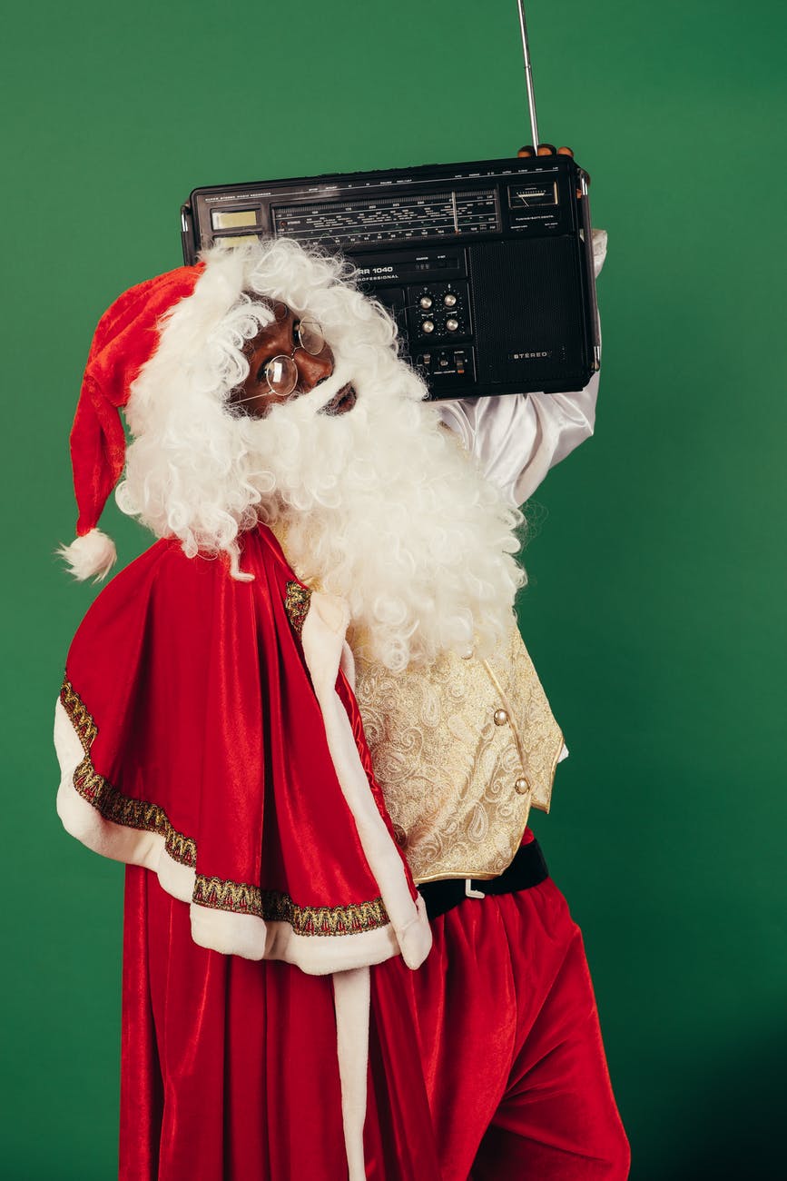 santa claus carrying a classic radio