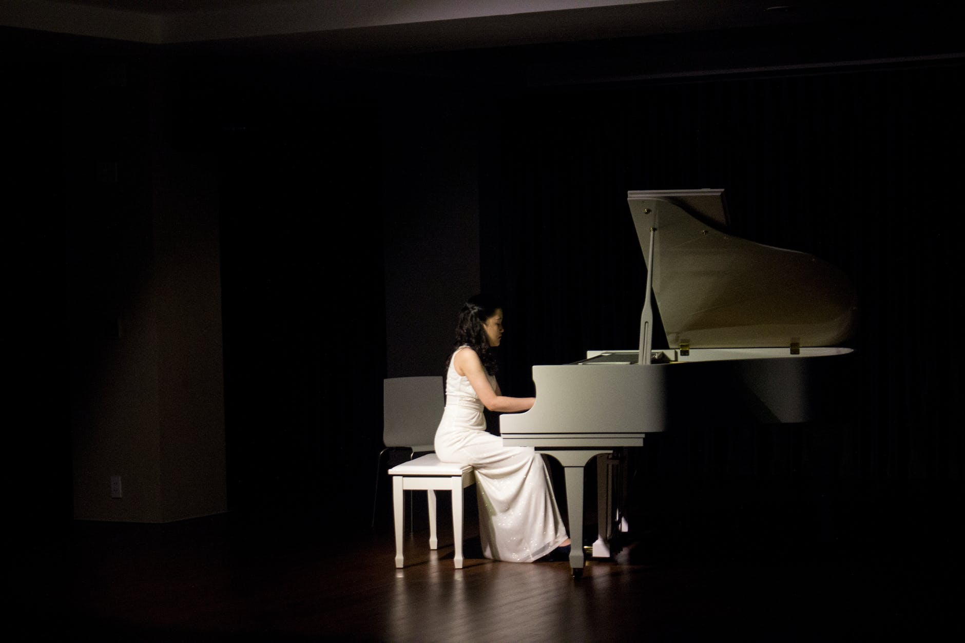 woman playing grand piano