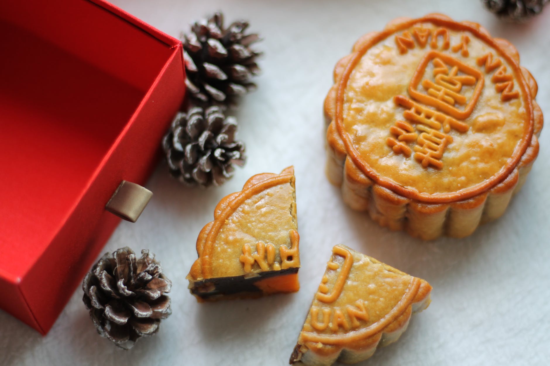 brown pie beside brown and white pine cone