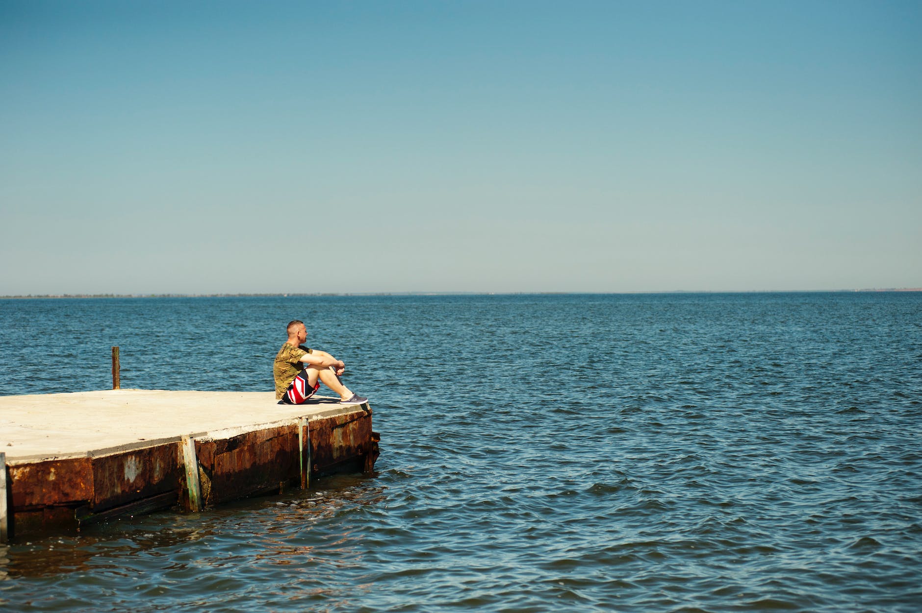 man sitting on dock